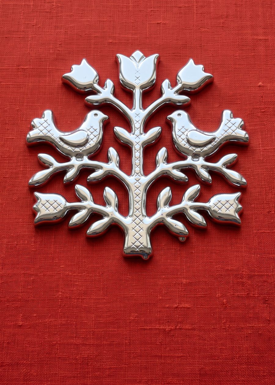 two chrome folk birds facing each other on a tulip-branch tree of life